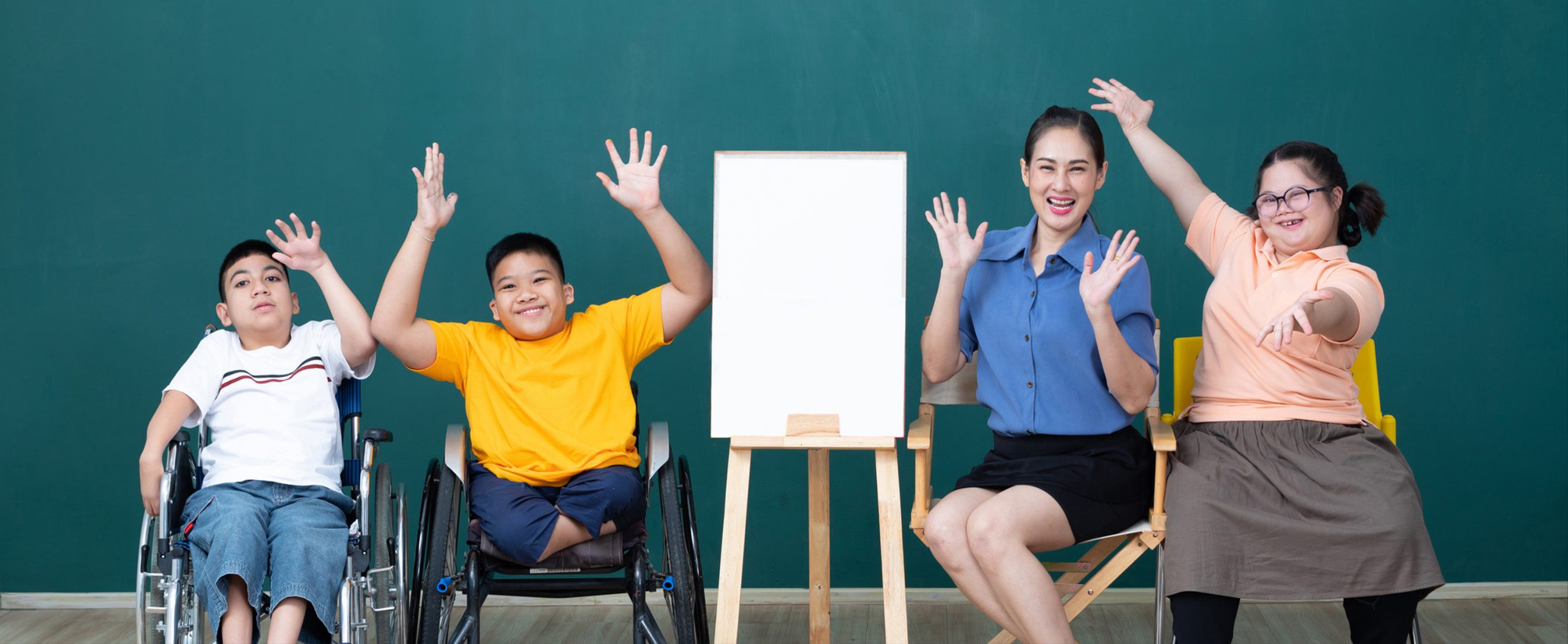 teacher and students in front of a whiteboard