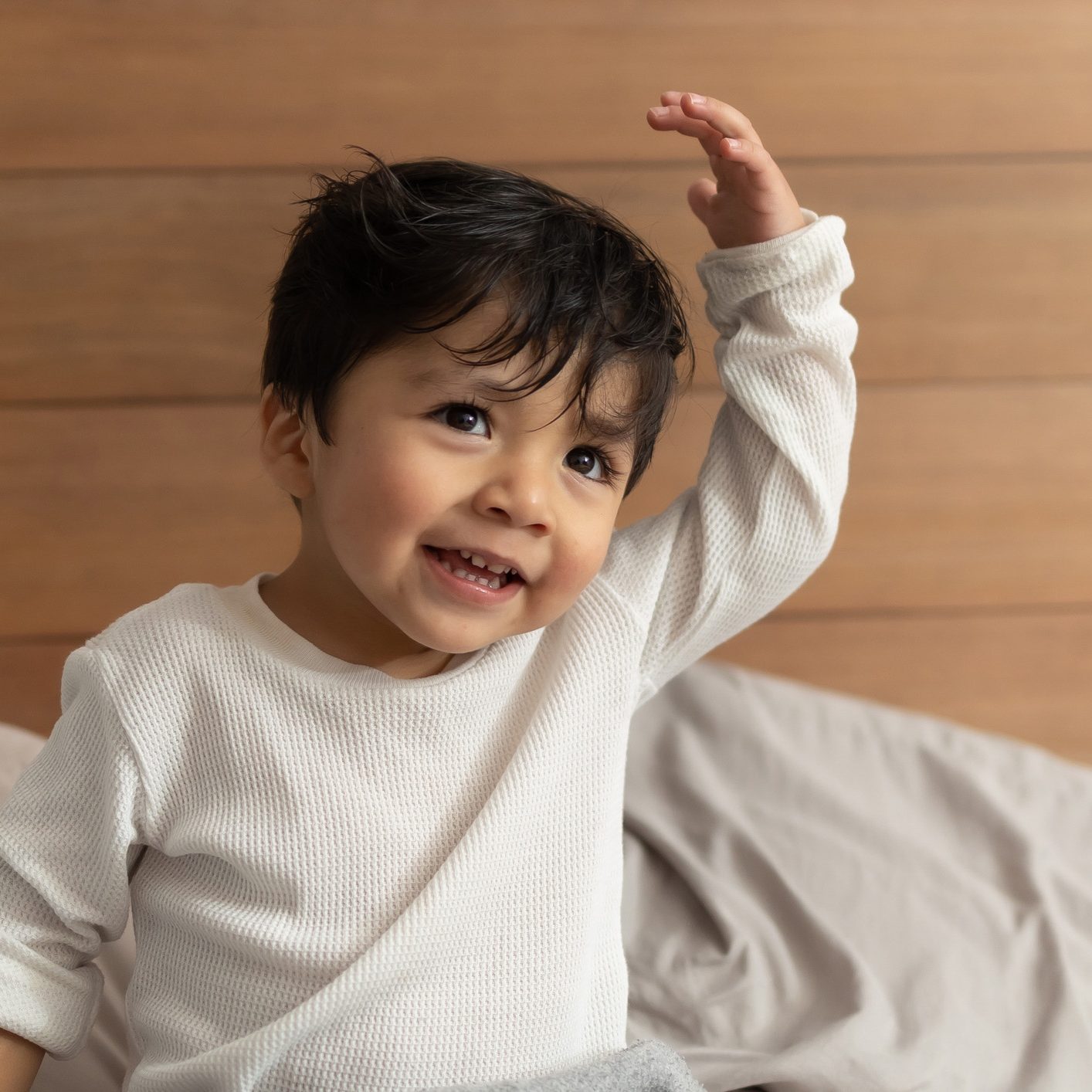 Mexican baby happy smiling after shower on bedroom